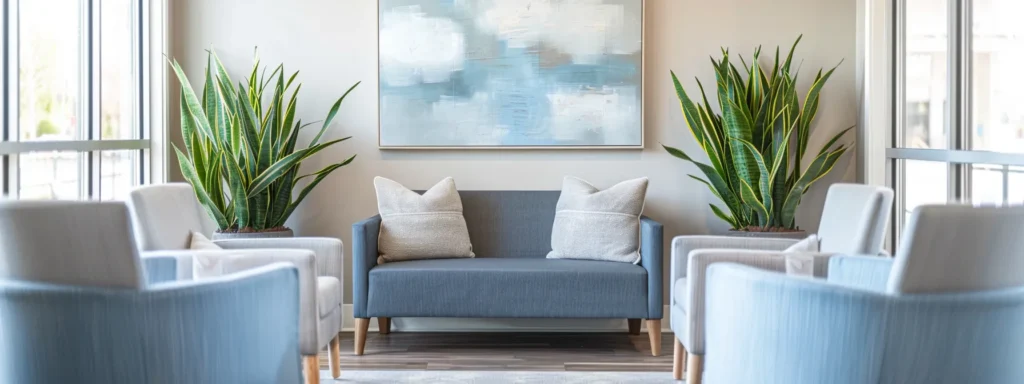 a serene and inviting therapy office in tennessee, featuring modern seating in soothing blue and grey tones, large windows allowing warm sunlight to illuminate the space, complemented by subtle abstract art and peaceful indoor plants, all captured in soft focus to evoke a sense of tranquility and safety.