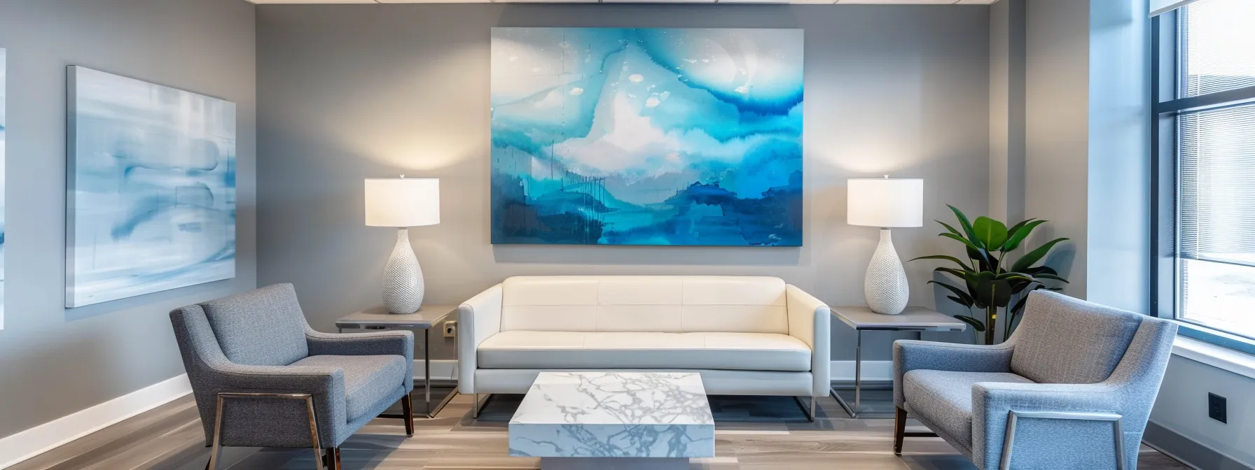 a serene therapy office interior bathed in warm natural light, featuring modern furnishings in calming blue and grey tones, complemented by soft lighting and abstract art, all designed to convey a tranquil atmosphere for discussions on detox timelines.