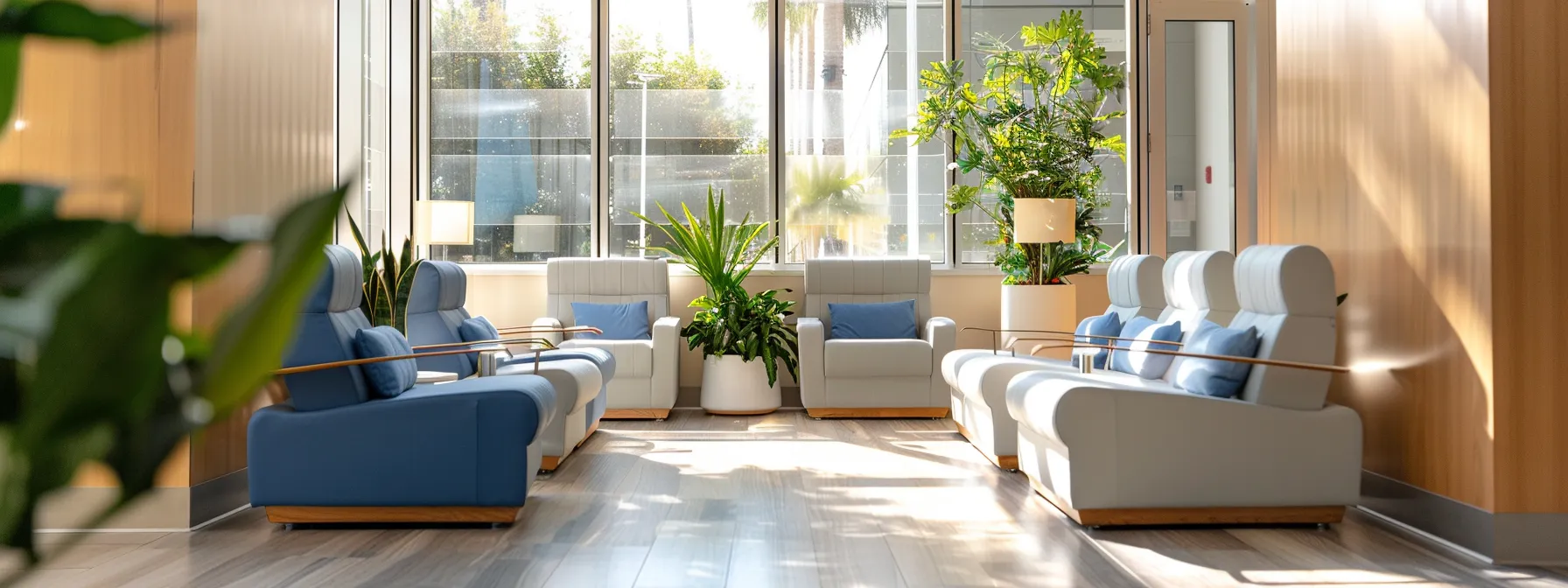 a serene therapy office interior features comfortable modern seating in calming blue and grey tones, with warm sunlight streaming through large windows, and soft decorative elements that create an inviting atmosphere for a partial hospitalization program.